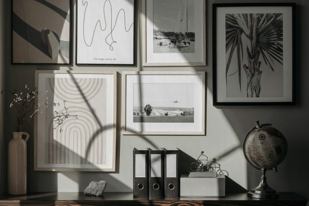 A stylish and modern interior featuring framed art prints, a globe, and decor items on a wooden surface.