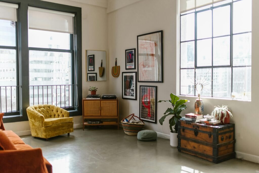 Contemporary apartment interior featuring large windows, stylish furniture, and wall art.