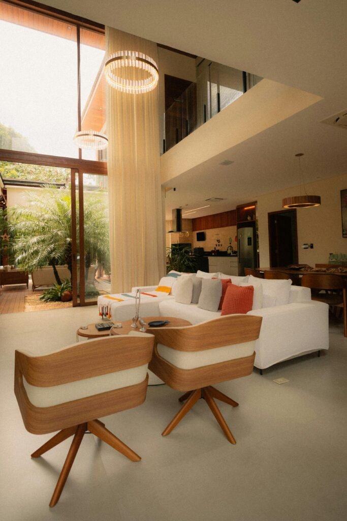 Spacious modern living room featuring luxurious furniture and abundant natural light through large windows.